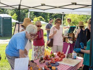 Visitors enjoy the tomato tasting at the 2021 Community Farm & Food Celebration