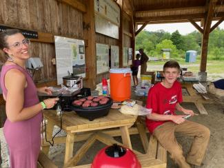 CAE Local Food Coordinator, Hayley Williams, and UVM intern, Finn Atwood, preparing a meal for everyone.